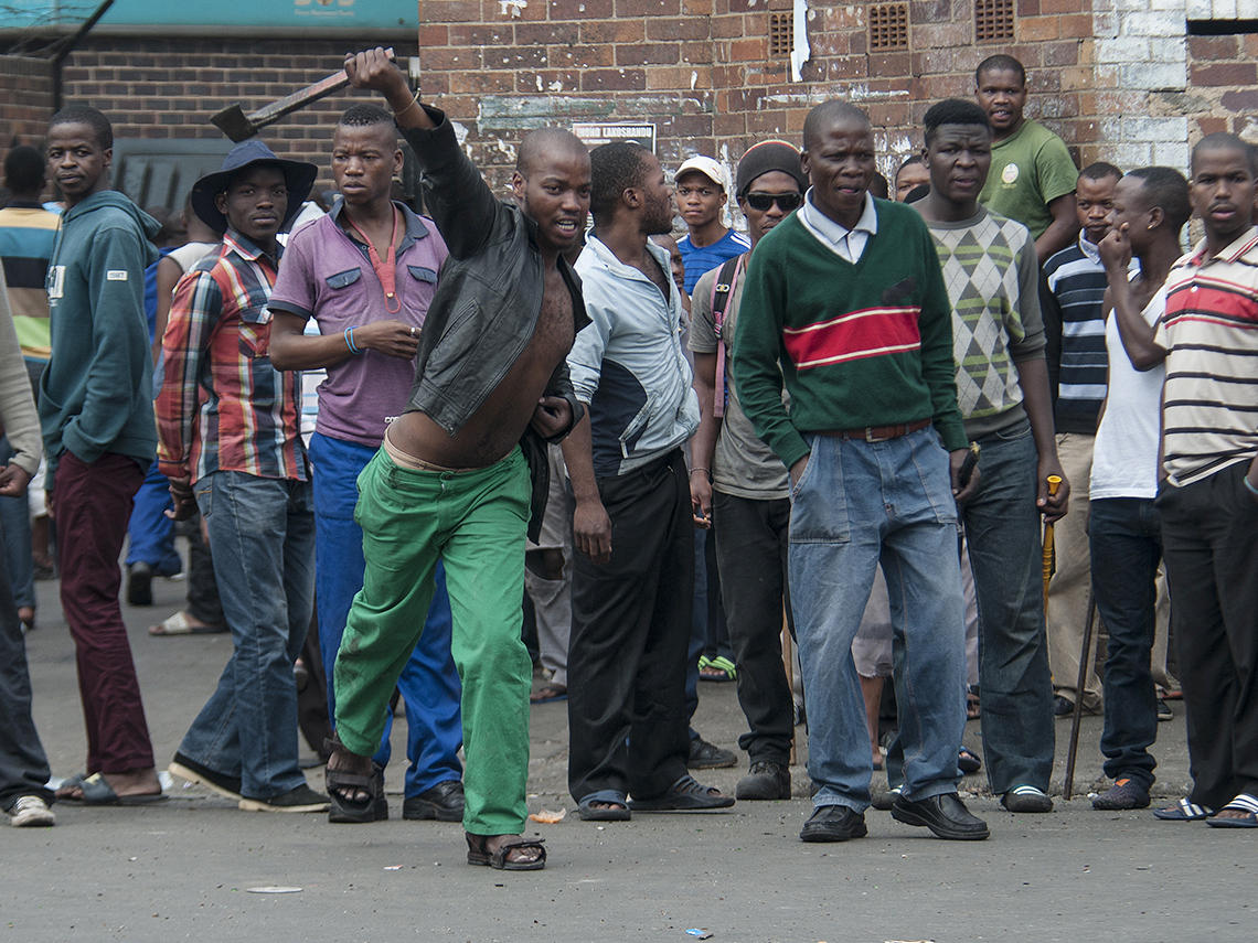 South African hostel dwellers demonstrate against foreigners in Johannesburg on Friday after overnight violence between locals and immigrants in the city.