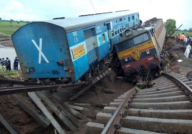 Two Indian passenger trains lay next to each other following a derailment after they were hit by flash floods on a bridge outside the town of Harda in Madhya Pradesh state on August 5, 2015. Two passenger trains derailed after being hit by flash floods on a bridge in central India, killing at least 27 people in the latest deadly accident on the nation's crumbling rail network. AFP PHOTO        (Photo credit should read STR/AFP/Getty Images)