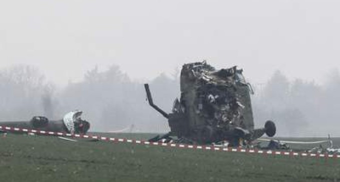 A Serbian army soldier stands next to the wreckage of a military helicopter near Belgrade airport